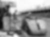 a black and white photo of a bugatti race car